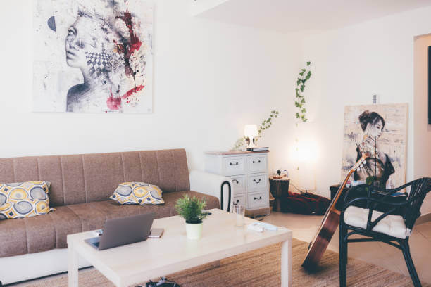 Modern living room with contemporary wall art, stylish furniture, and indoor plants – showcasing results of professional painting service in Dubai